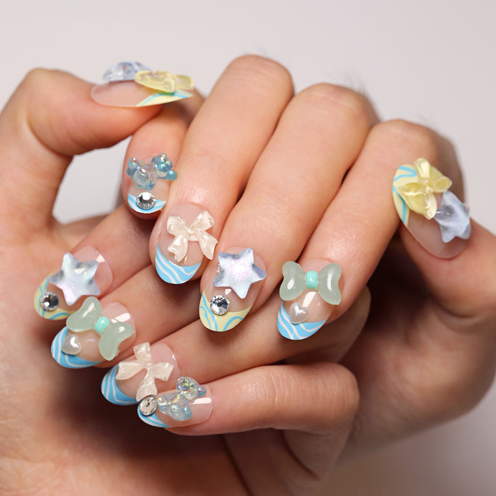 Artificial nail art with colorful pastel designs and 3D embellishments Kalsten