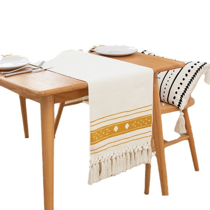 Woven table runner with fringes and ethnic chevron pattern