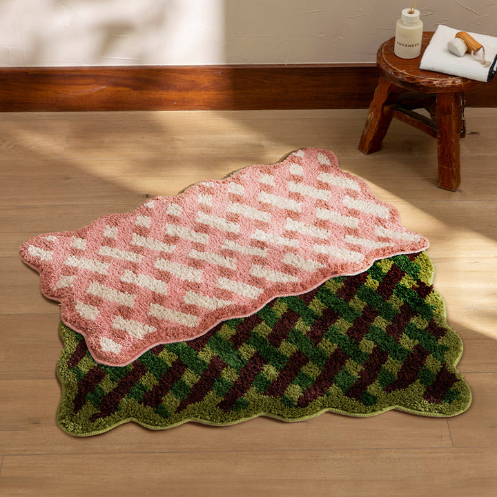 Tufted bathroom mat with wavy edge and geometric relief