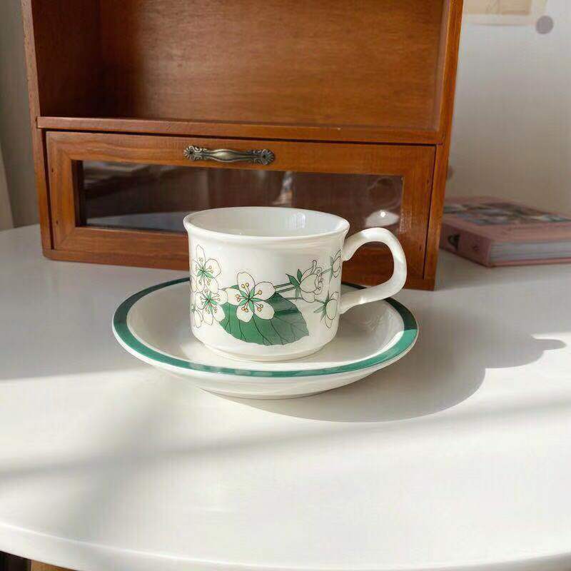 Fine porcelain tea cup with saucer and delicate floral motif