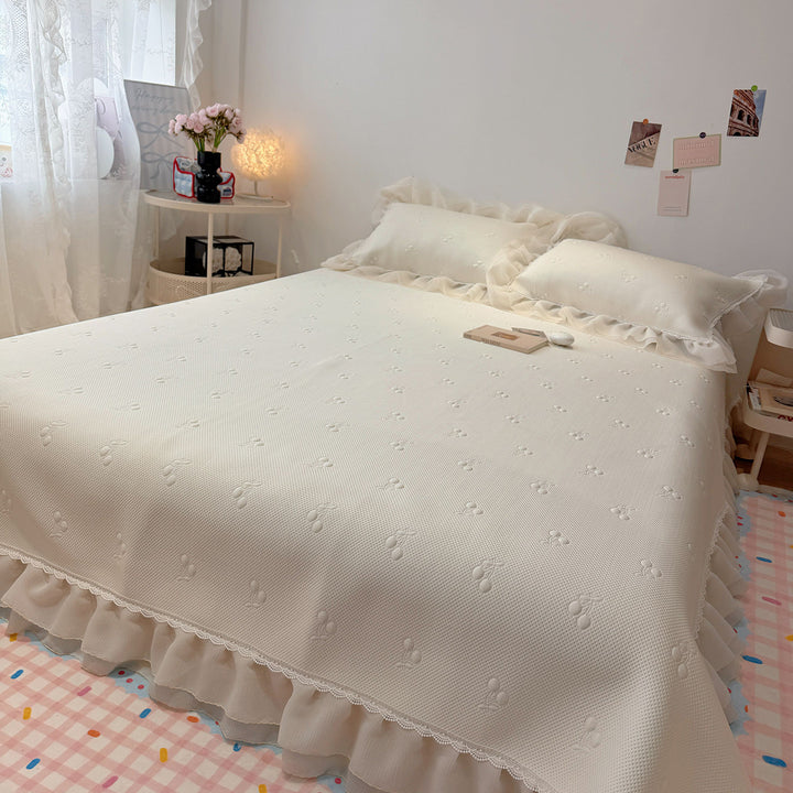 Quilted bedspread with ruffle and delicate floral quilting