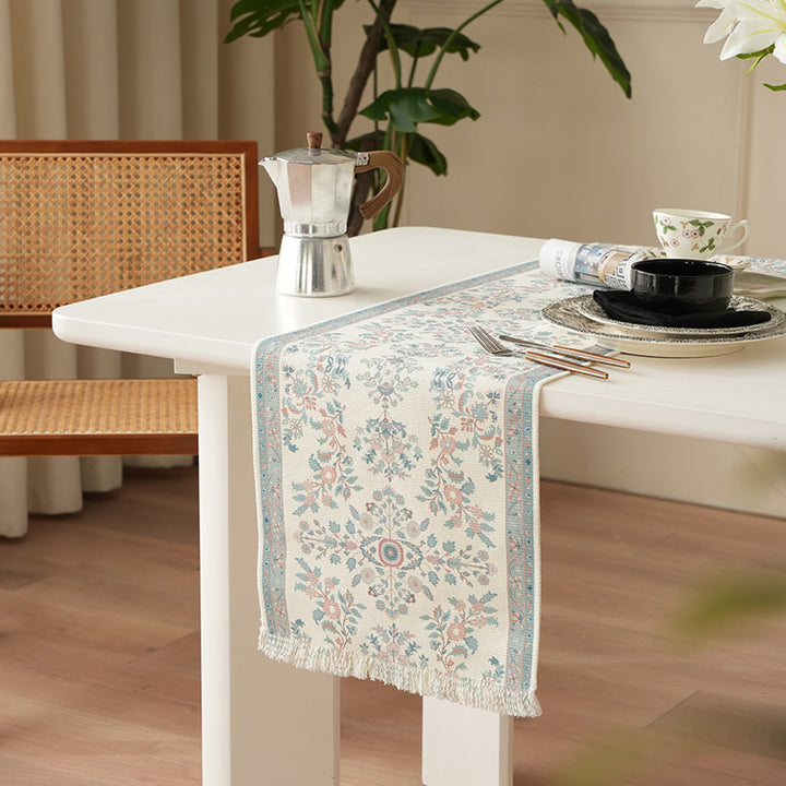 Jacquard table runner with floral border pattern and fringes