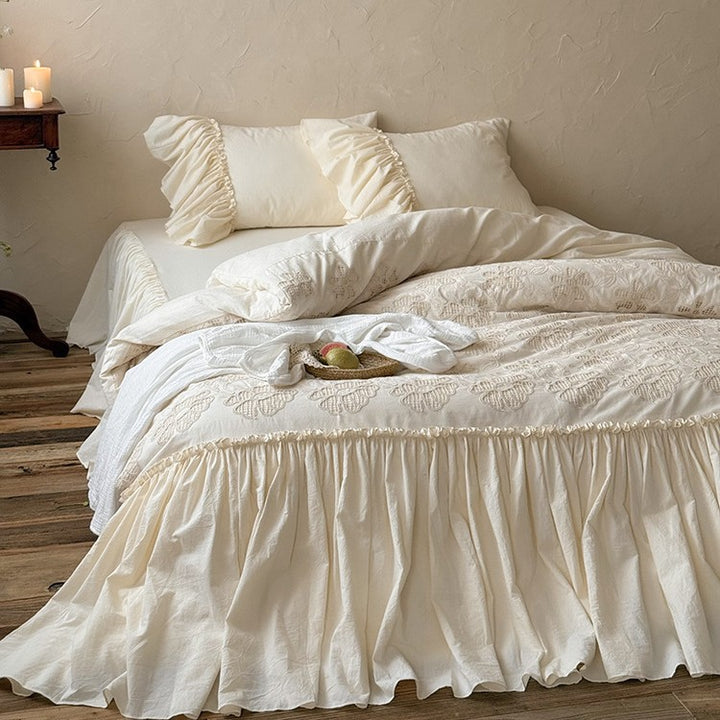 Vintage-inspired bed skirt and bedspread with wide ruffle and delicate embroidery