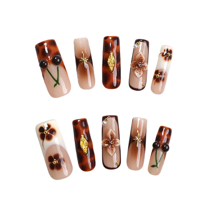 Elegant nail art set with floral and golden accents Kalsten
