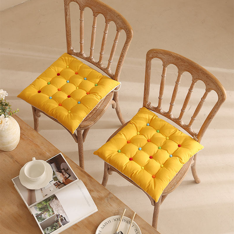 Padded quilted seat cushion with colorful button applications and non-slip underside Kalsten