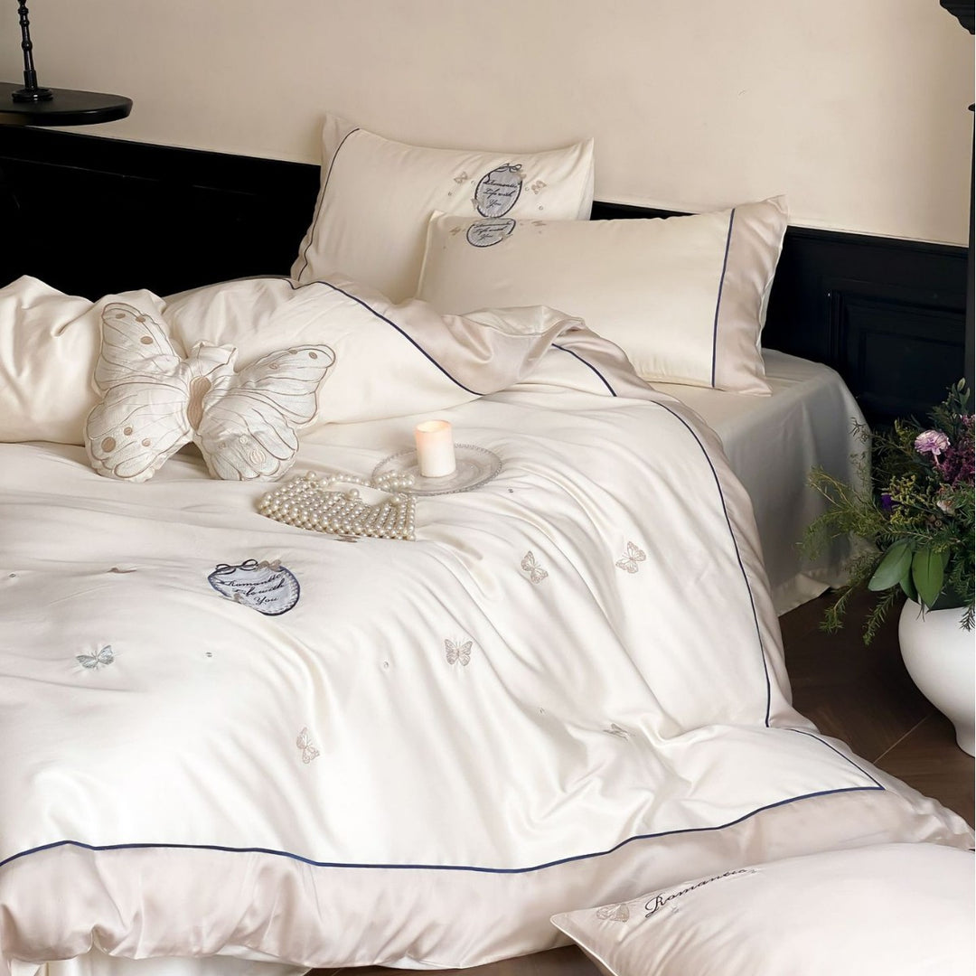 Luxurious cotton satin bedding set with embroidered butterfly appliqués and fine piping