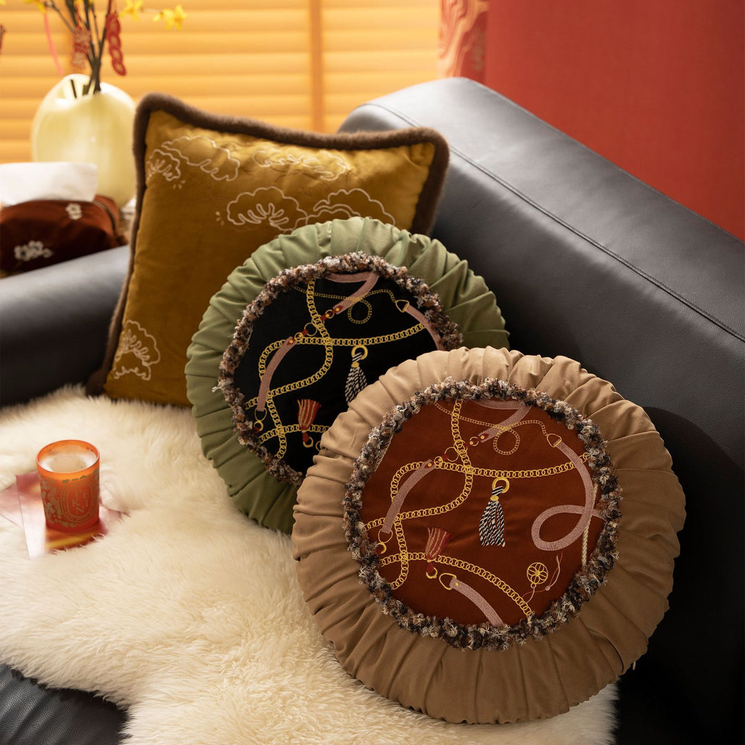 Round decorative cushion with pleated hem and embroidered central panel