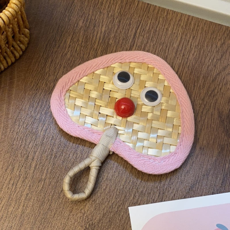Handcrafted fan with playful face motif Kalsten