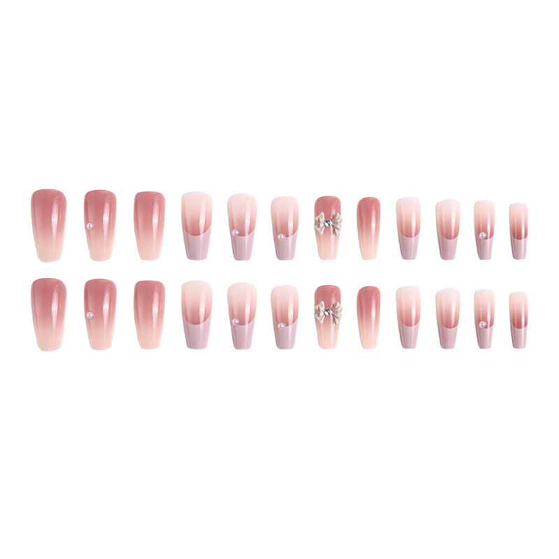 Artificial nail set with elegant ombre design and delicate bow embellishments Kalsten