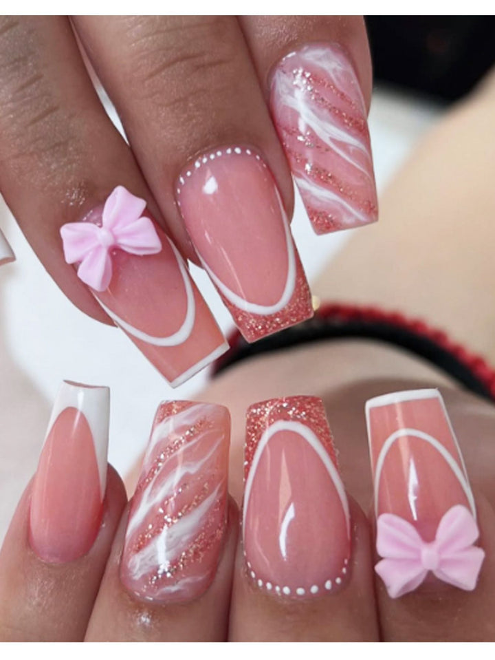 Acrylic nail set with elegant glitter design and playful bow accents Kalsten