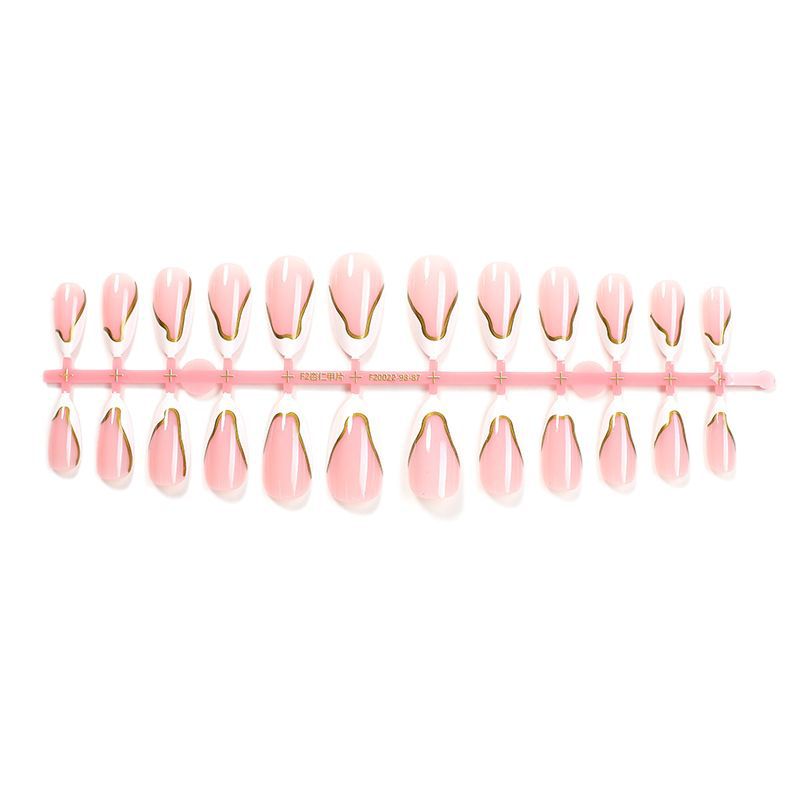 Artifical nail set with elegant gold trim and delicate pink Kalsten
