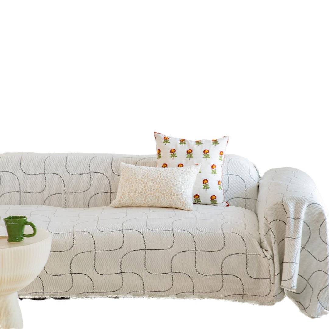 Woven sofa cover with geometric pattern, elastic corners and anti-slip