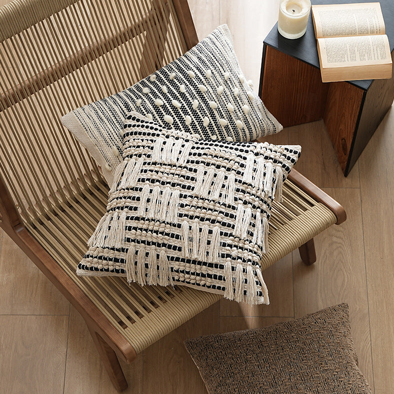 Square woven decorative pillow cover with tiered tassels and textured cotton surface