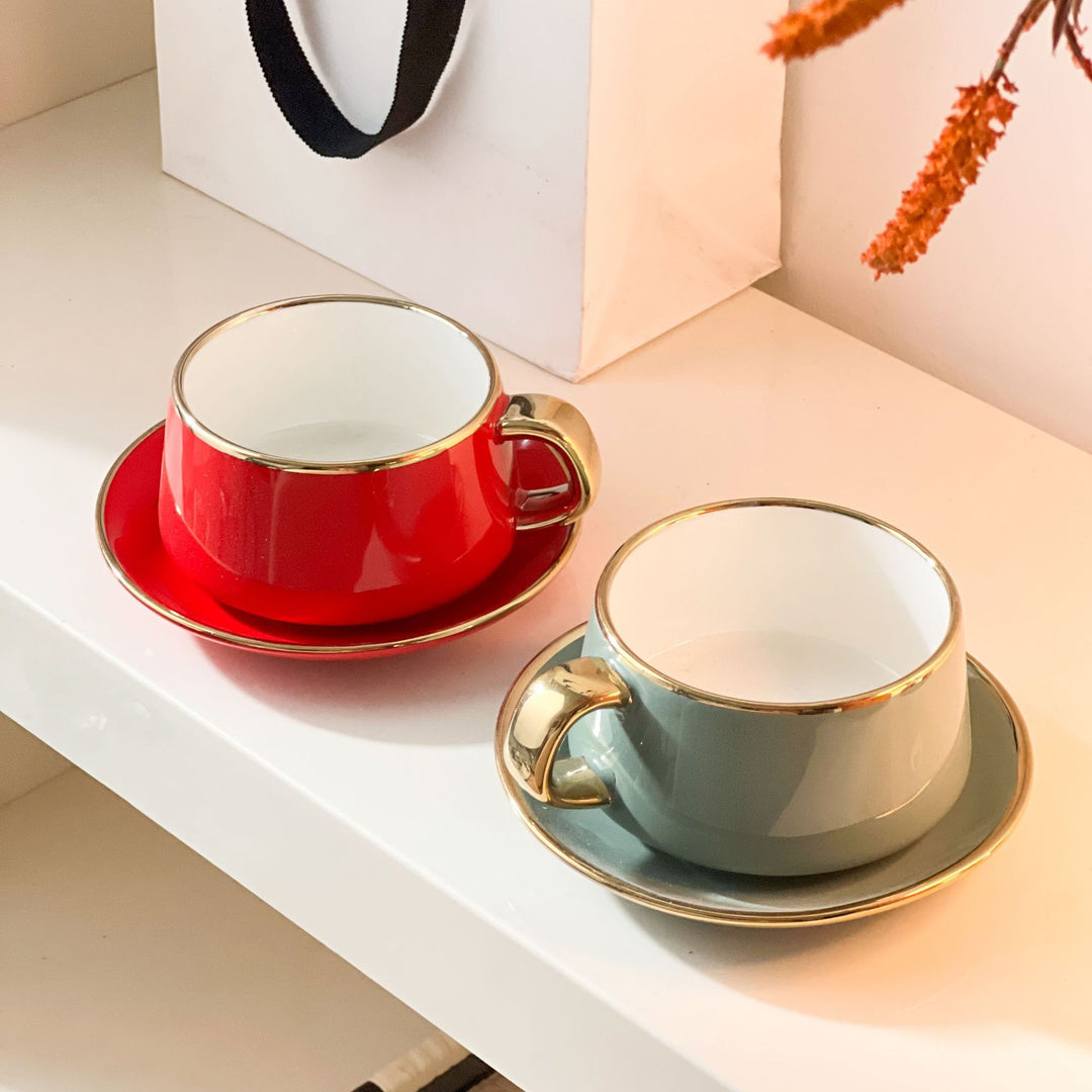 Elegant porcelain cup with saucer and sculptural gold handle