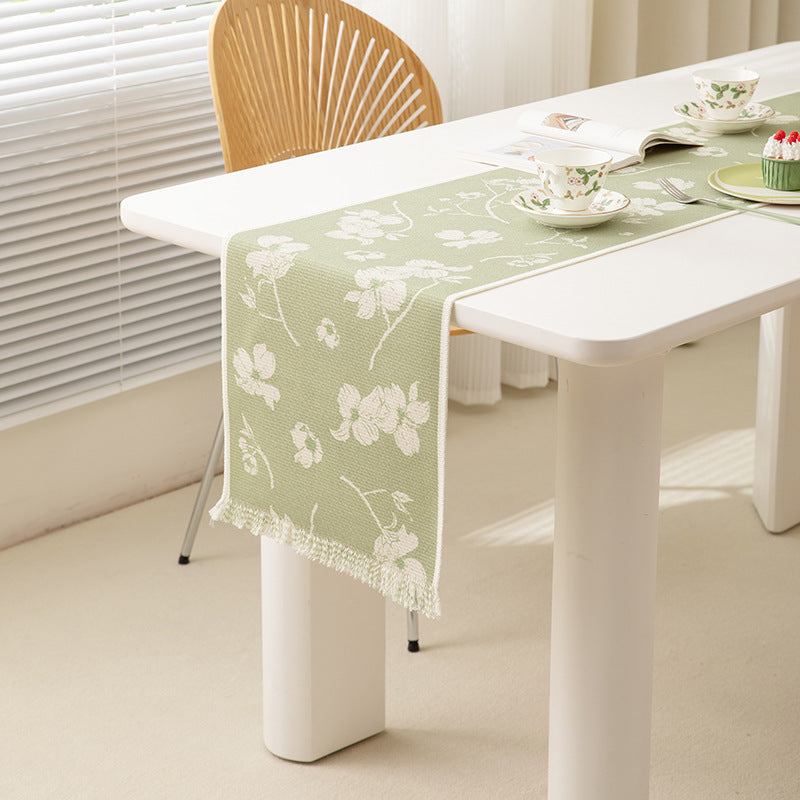 Woven table runner with floral jacquard pattern and fringed edge Kalsten