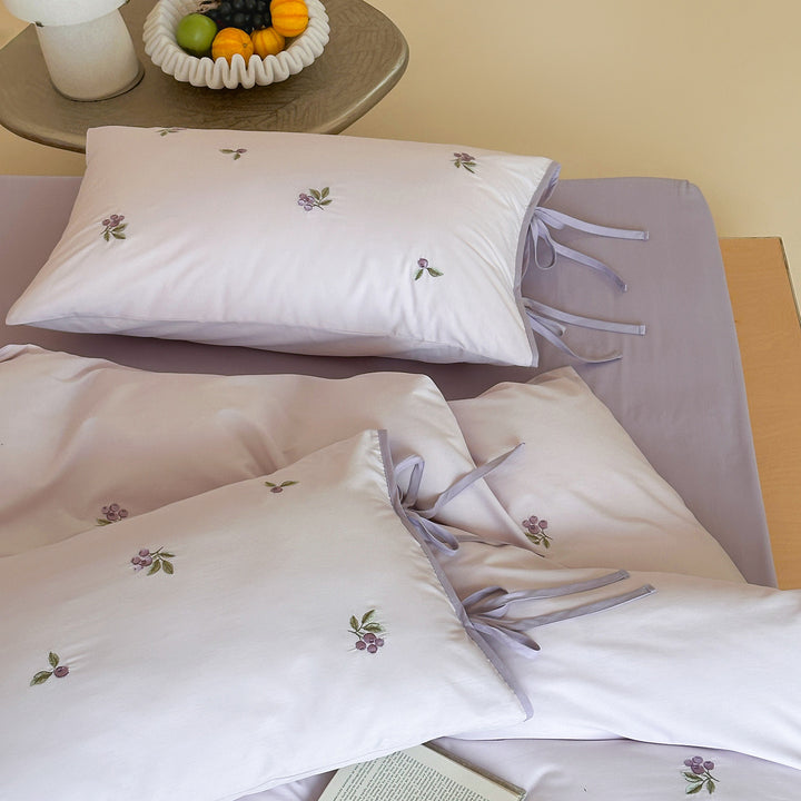 Reversible cotton bedding set with fine check pattern, cherry embroidery, and decorative tie ribbons