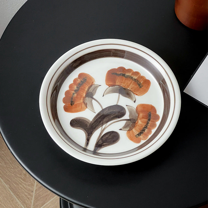 Deep porcelain plate with floral rim ornamentation and contrasting inner mirror