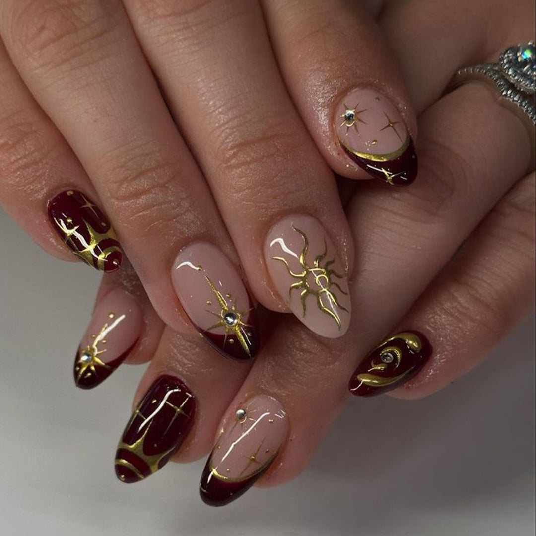 Artful nail art with golden accents and mystical motifs Kalsten