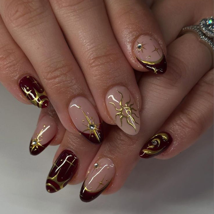 Artful nail art with golden accents and mystical motifs Kalsten
