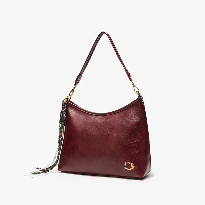 Elegant Hobo Handbag with Decorative Tassels