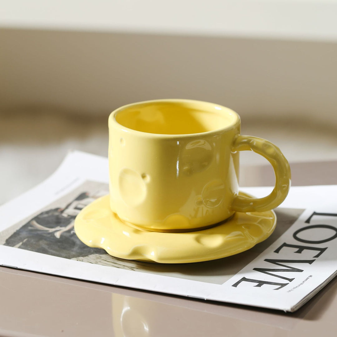 Sculptural ceramic cup set with flowing glaze and textured saucer