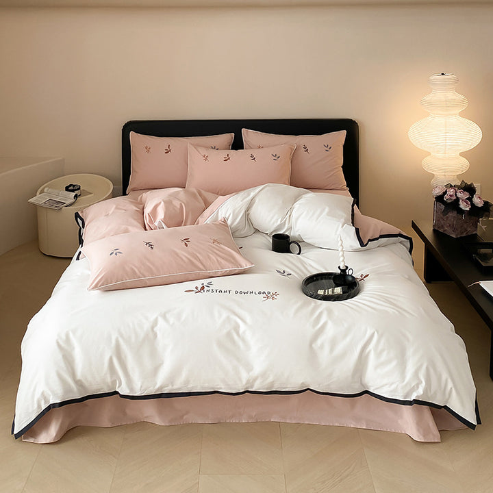 High-quality cotton satin bedding set with delicate embroidery, reversible feature & piping edge