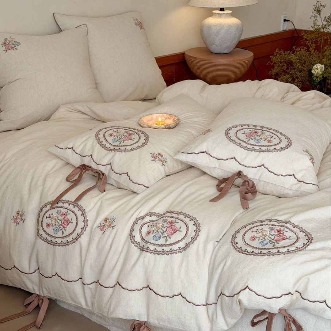 Romantic cotton-linen bedding set with embroidered flower medallions and ruffles