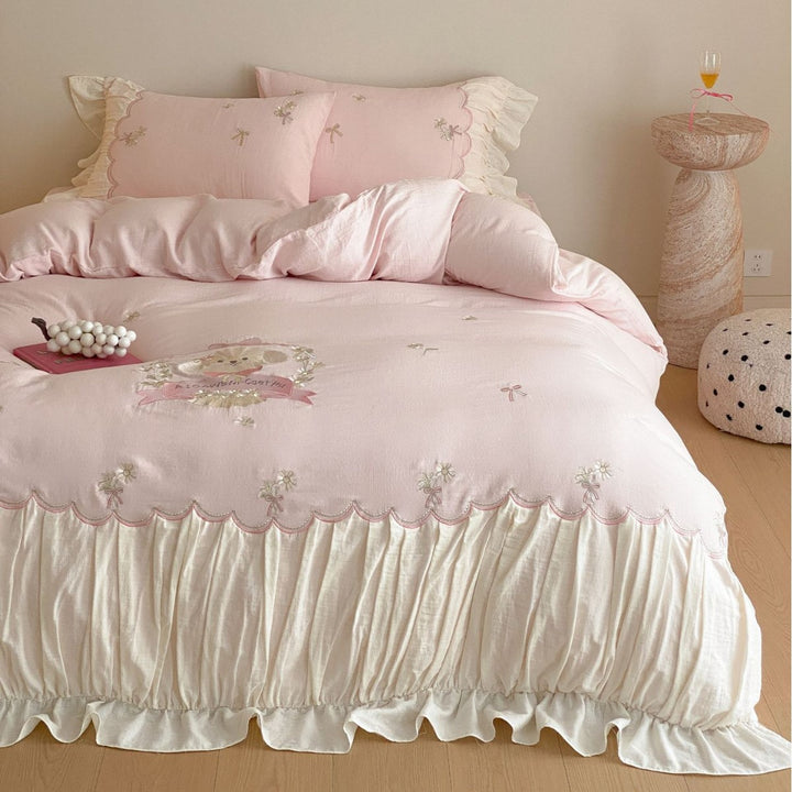 Playful cotton satin bedding set with ruffled bed skirt, floral embroidery, and frill cushion