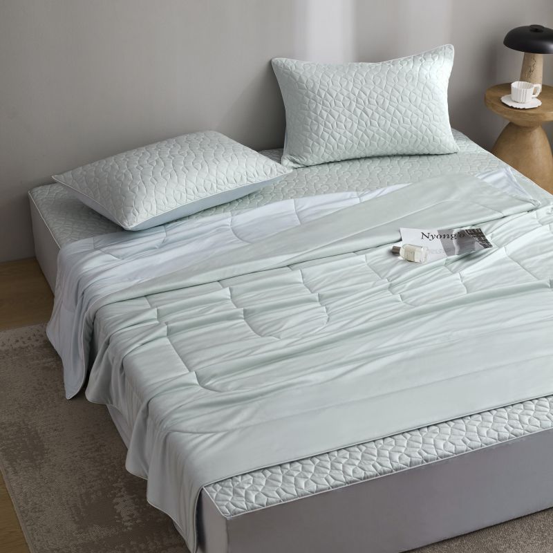 Quilted bedding set with reversible satin blanket and mattress protector