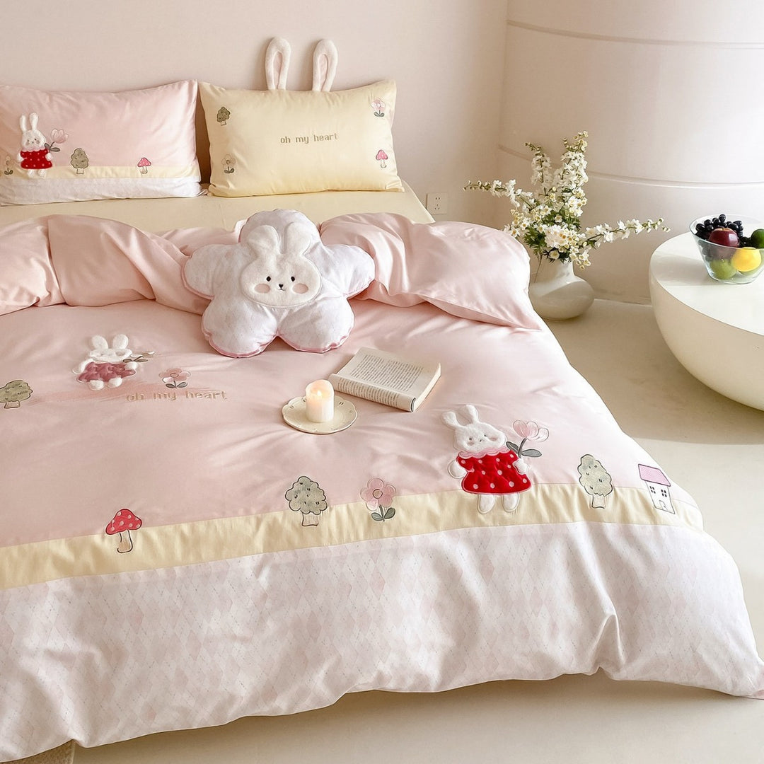 Playful cotton satin bed linen set with embroidered bunny appliqués and plush pillow