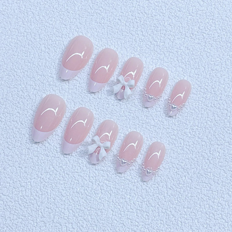 Elegant artificial nails with curved tips and decorative bows Kalsten