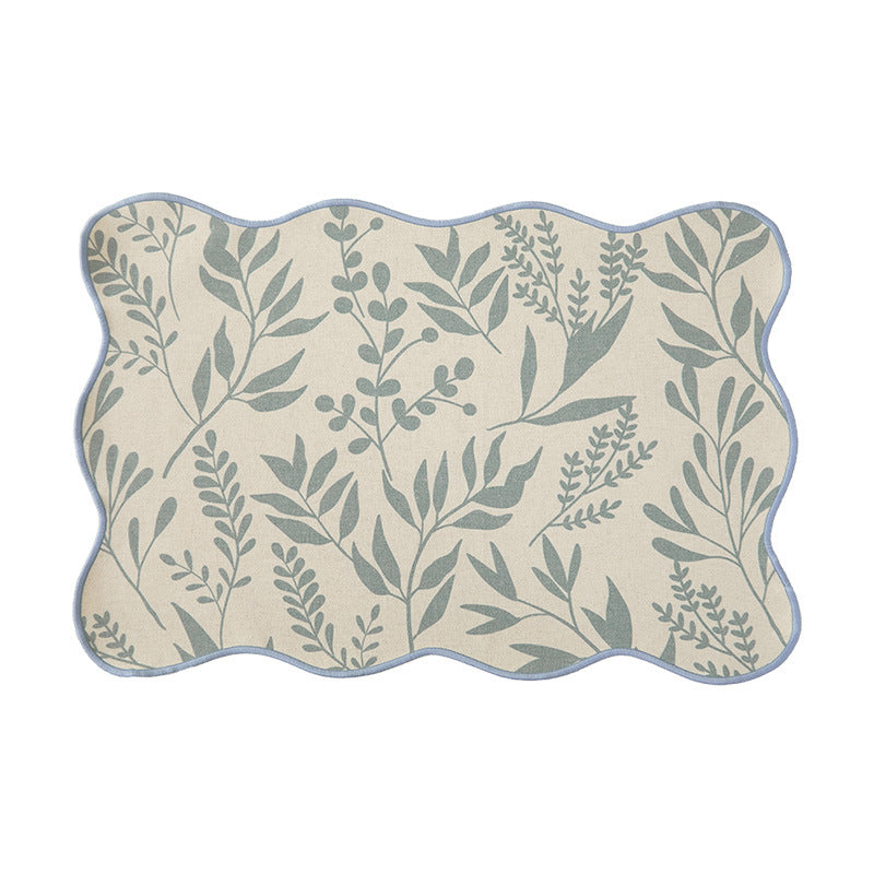Shaped placemat made of cotton-linen with wavy edge and leaf pattern