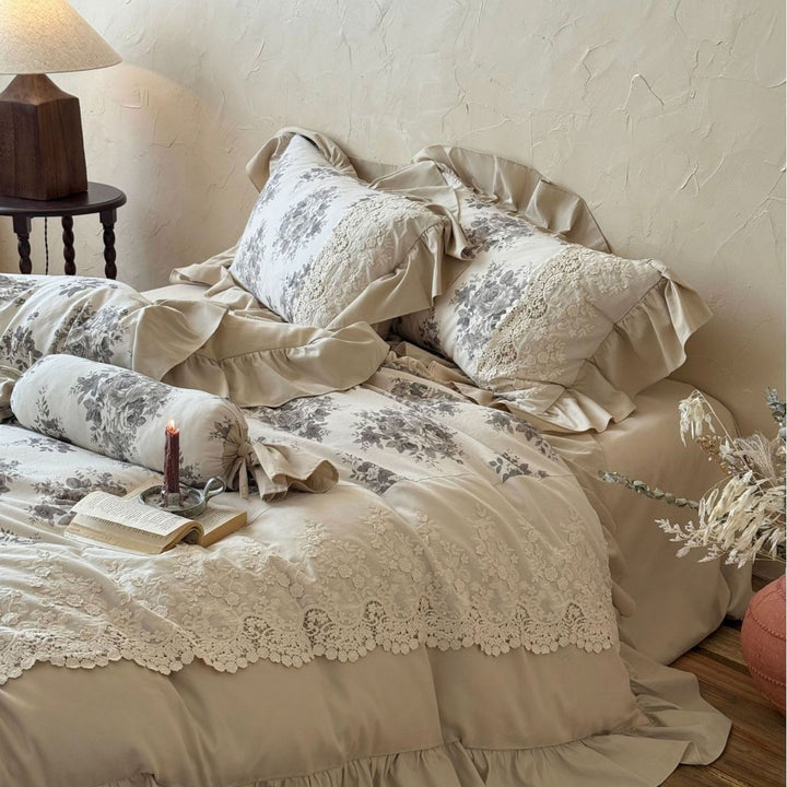 Bedding set in French country house style with lace trim, ruffled bed skirt, and subtle toile floral design