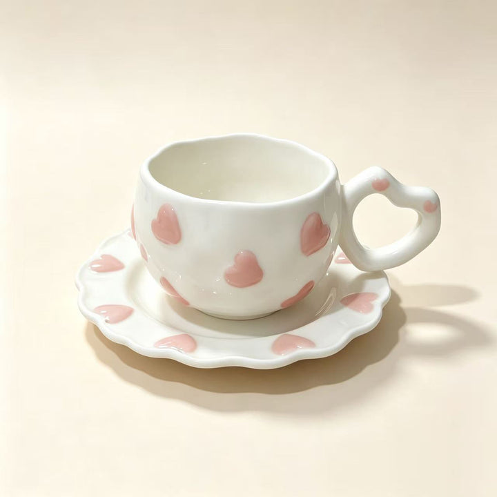 Porcelain cup set with heart-shaped handle and embossed decorative hearts