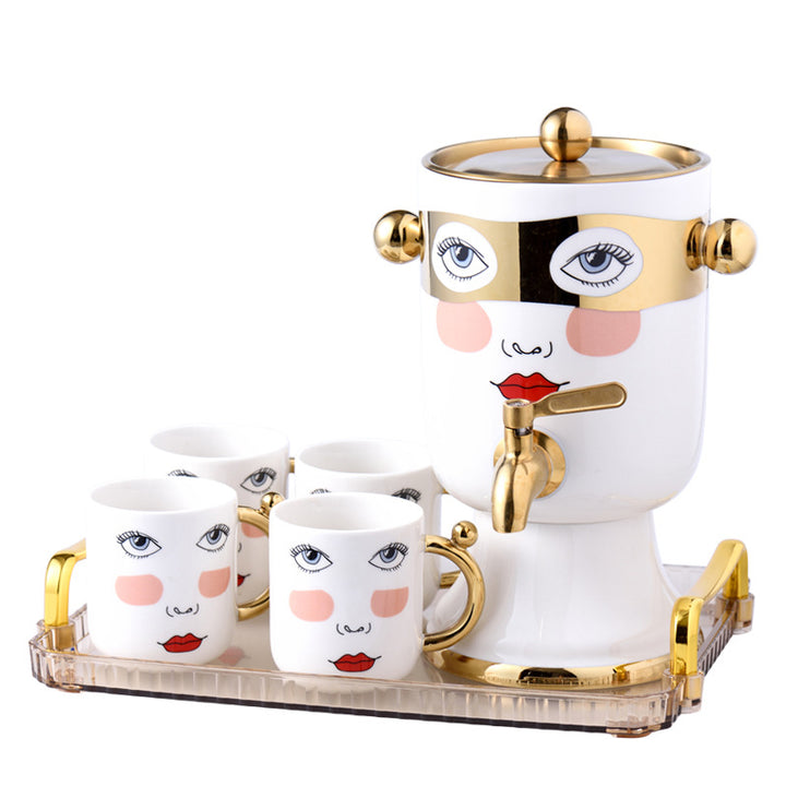 Decorative ceramic beverage dispenser with tap, hand-painted face and gold-finished lid