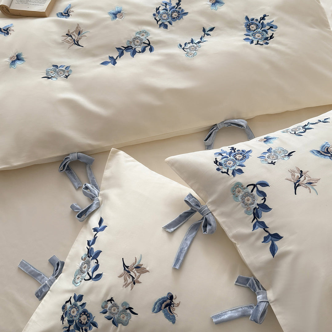 Embroidered satin bedding set with delicate floral details