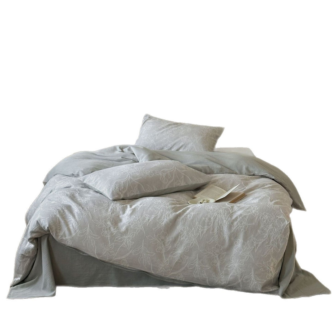 Finely woven cotton bedding set with embroidered floral relief and reversible cover
