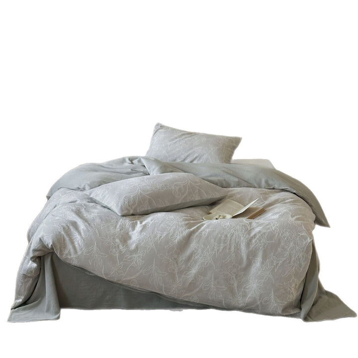 Finely woven cotton bedding set with embroidered floral relief and reversible cover