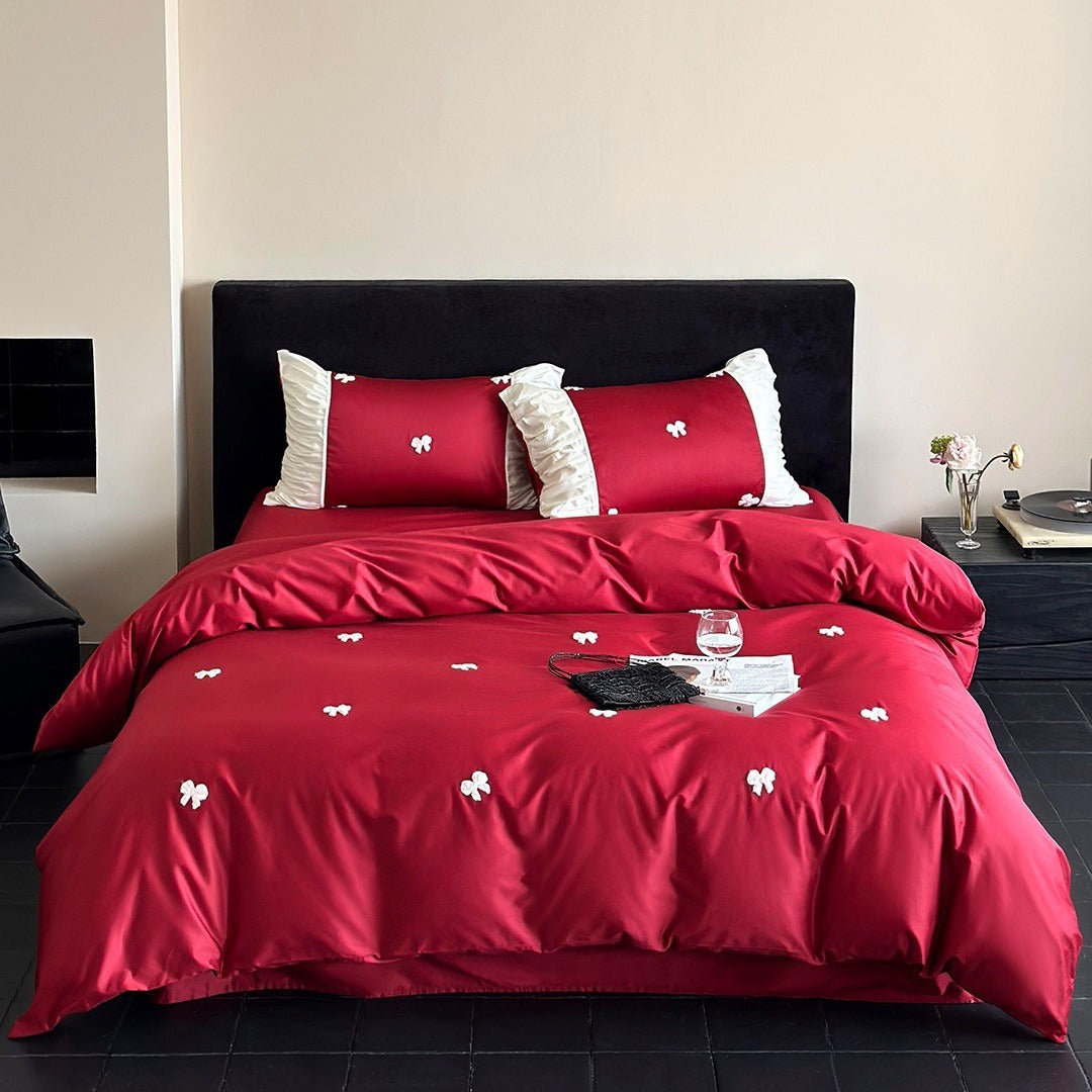 Luxurious cotton satin bedding set with embroidered bows and ruffle details
