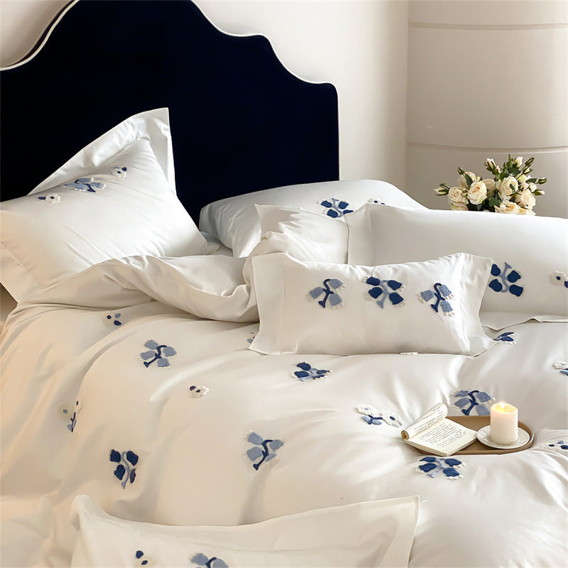 Embroidered cotton satin bedding set with subtle blue flower patterns
