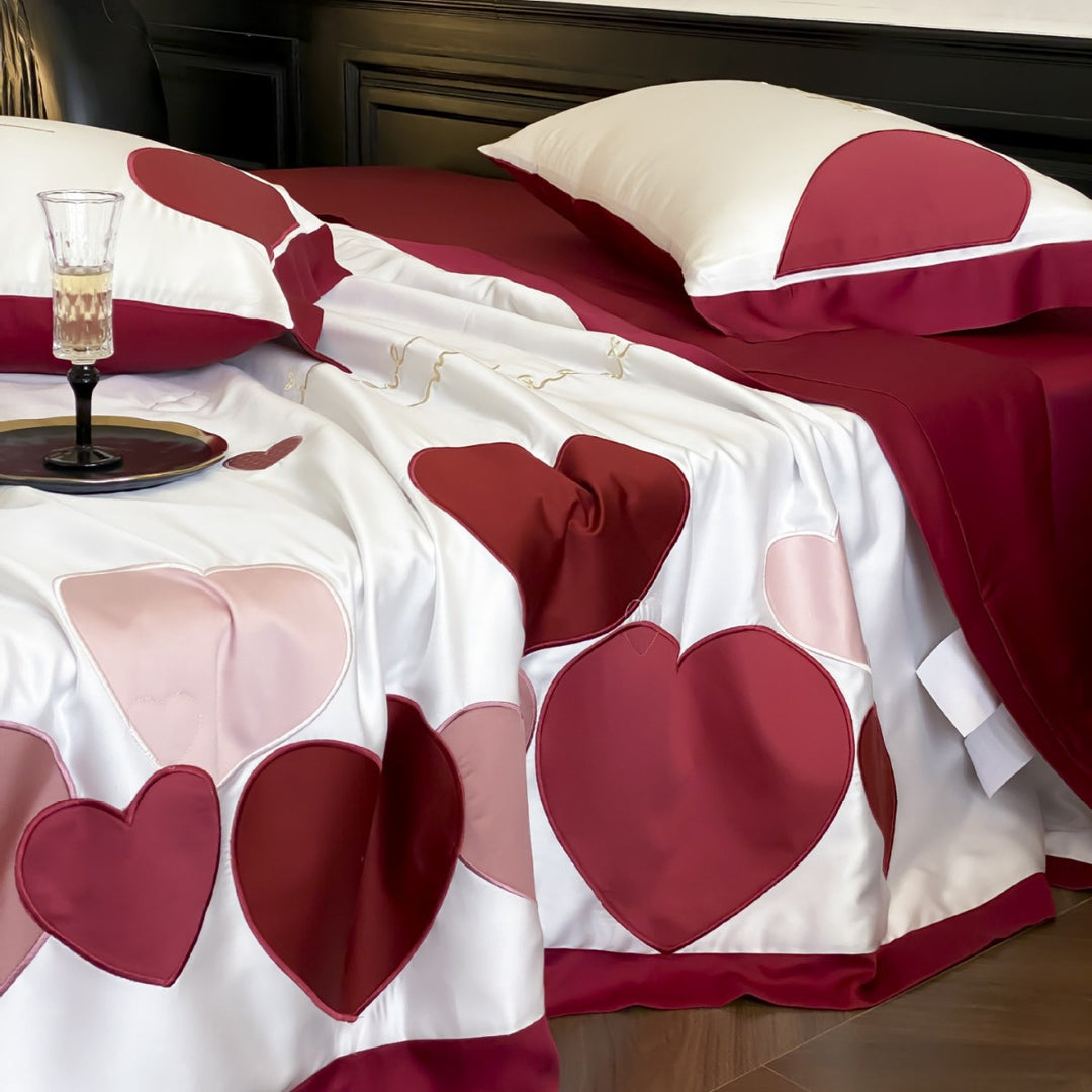 Bedding set with quilted heart appliqués and satin border