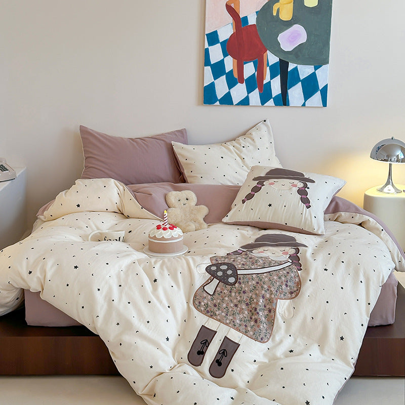 Bedding set with appliquéd doll motif and star pattern