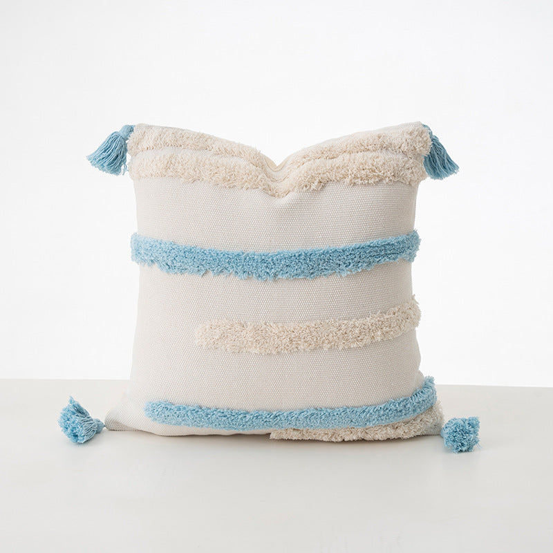 Square decorative cushion with boucle stripes, woven texture, and corner tassels