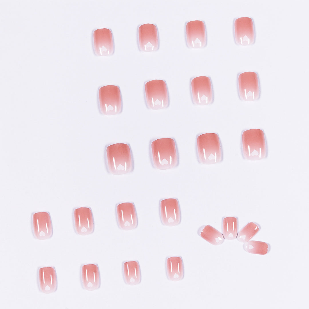 Artful nail art with heart-shaped accents and gentle ombre effect Kalsten