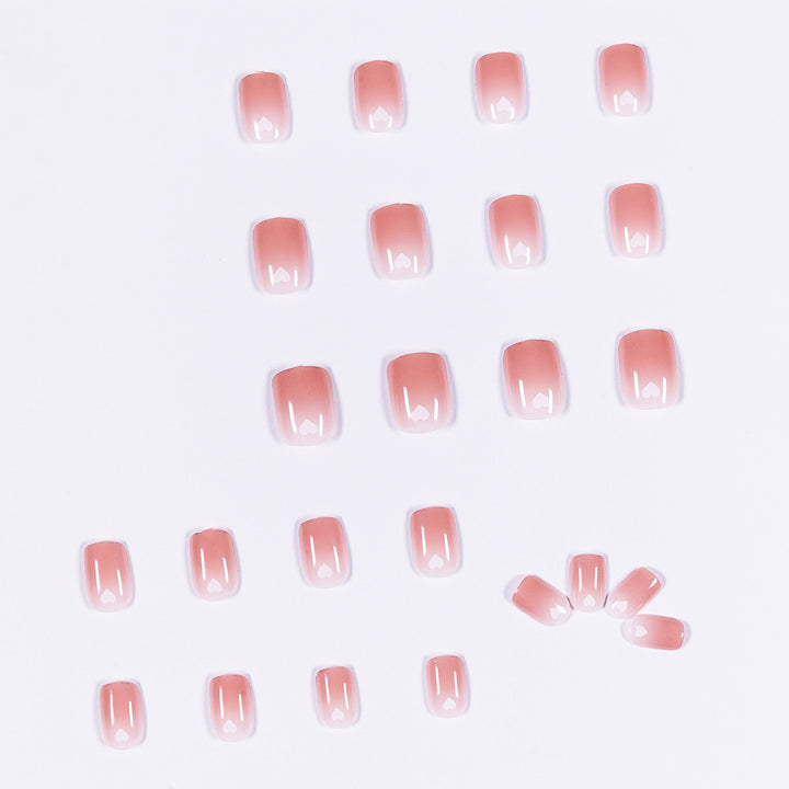 Artful nail art with heart-shaped accents and gentle ombre effect Kalsten