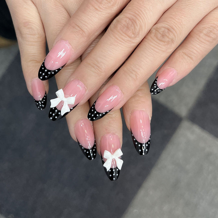 Decorative Stiletto Press-On Nail Art with Bow and Polka Dot Design