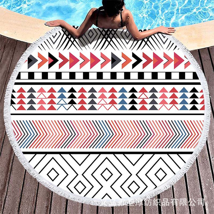 Round beach towel with colorful, tropical floral pattern and fringe decoration Kalsten