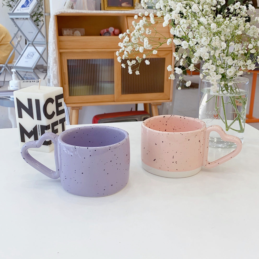 Ceramic mug with heart-shaped handle and speckle design