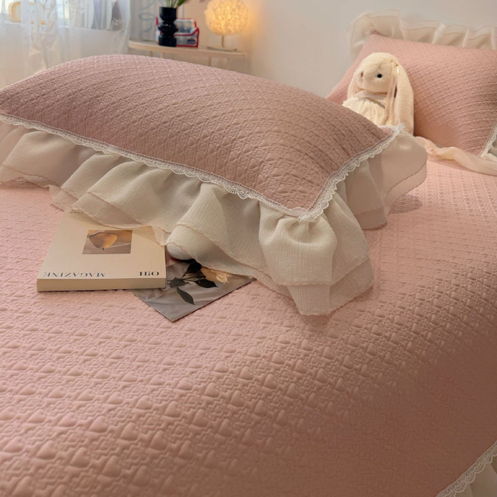 Quilted bedspread with ruffle and delicate floral quilting