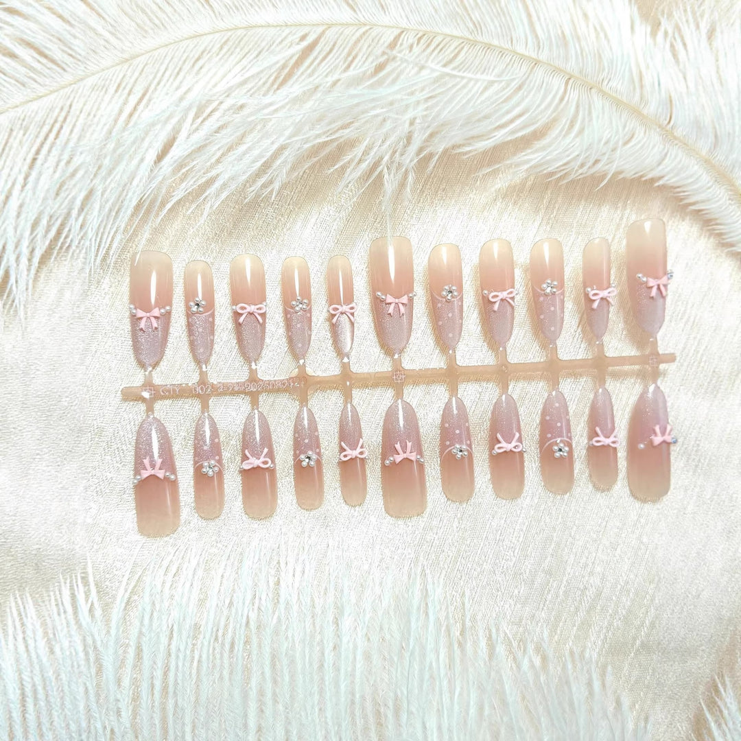 Artificial nails with elegant glitter and bow design Kalsten